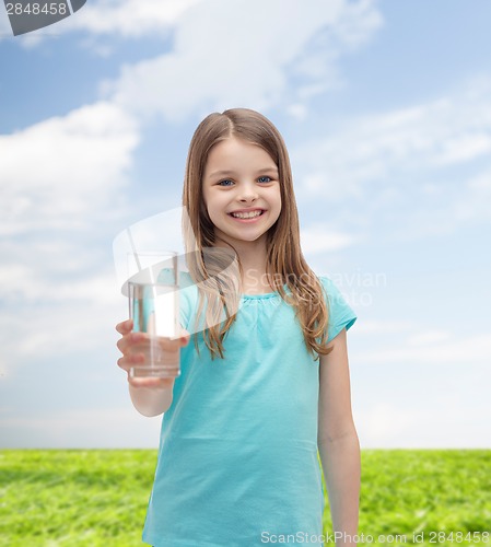 Image of smiling little girl giving glass of water