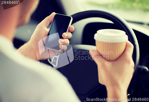 Image of man using phone while driving the car