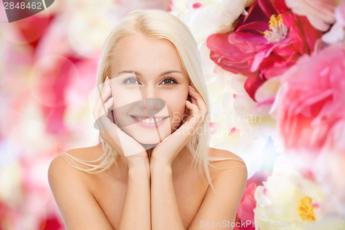Image of beautiful woman touching her face skin