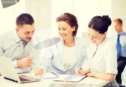 Image of business team discussing something in office