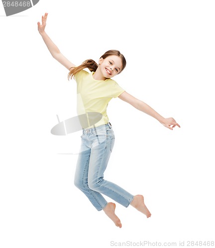 Image of smiling little girl jumping