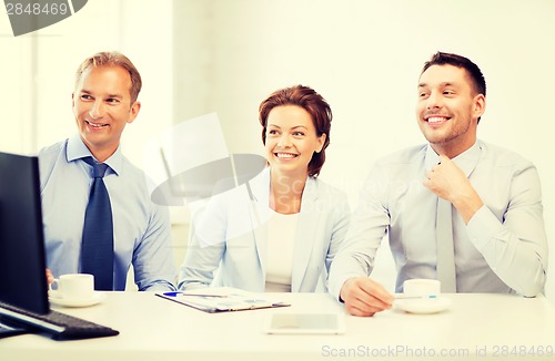 Image of business team discussing something in office