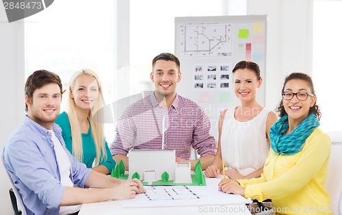 Image of smiling architects working in office