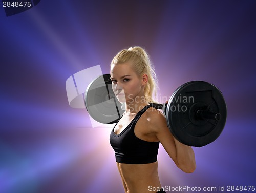 Image of sporty woman exercising with barbell