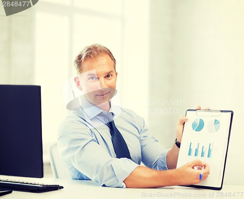 Image of businessman showing graphs and charts