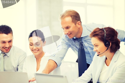 Image of group of people working in call center