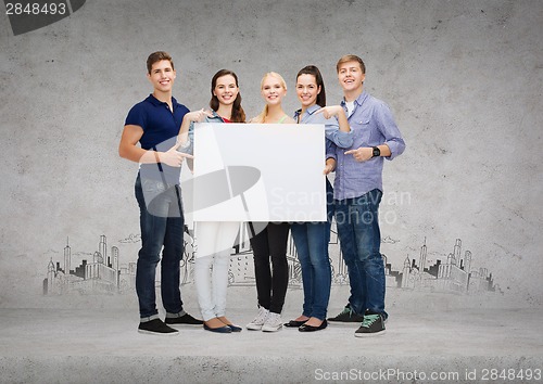 Image of group of smiling students with white blank board