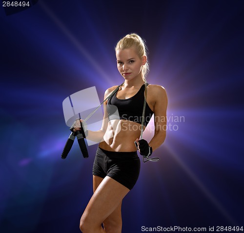 Image of sporty woman with skipping rope