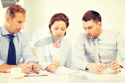 Image of business team discussing something in office