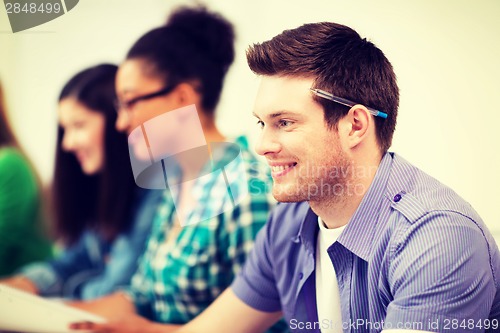 Image of student with computer studying at school