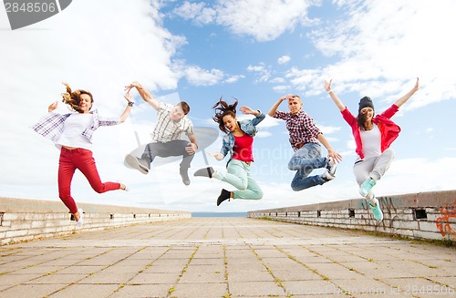 Image of group of teenagers jumping