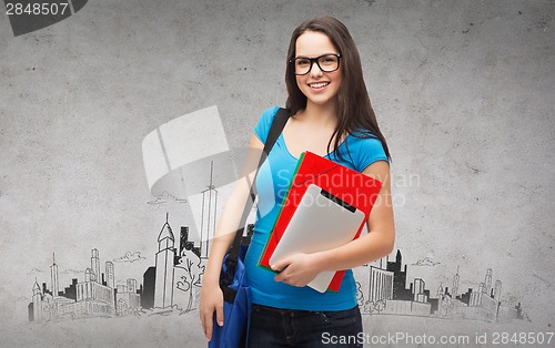 Image of smiling student with bag, folders and tablet pc