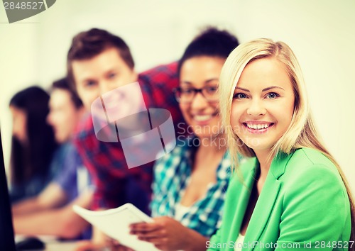 Image of students with computer studying at school