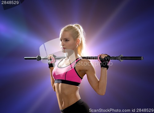 Image of sporty woman exercising with barbell