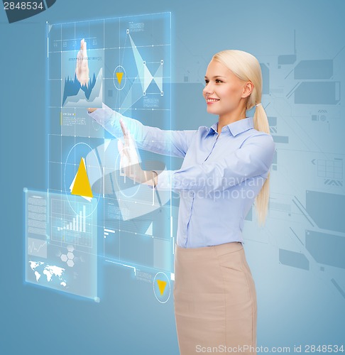 Image of smiling businesswoman working with virtual screen