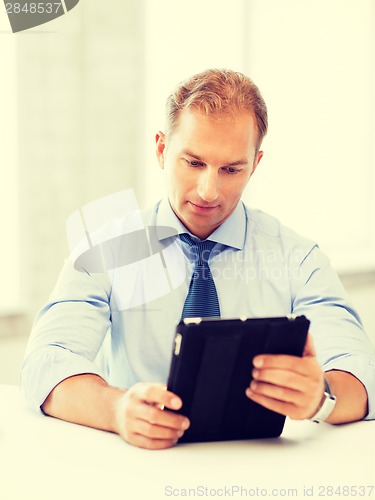 Image of businessman with tablet pc in office