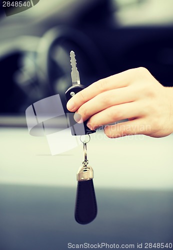 Image of man with car key outside