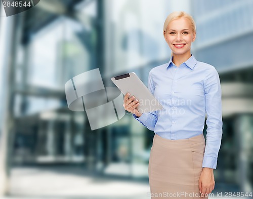 Image of smiling woman looking at tablet pc computer