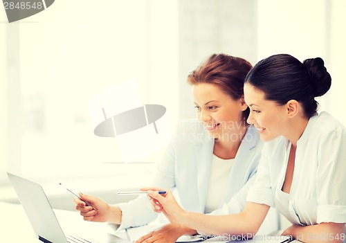 Image of businesswomen working with laptop in office