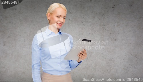 Image of smiling woman looking at tablet pc computer