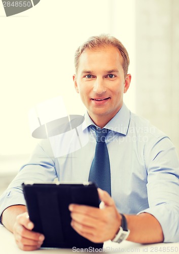 Image of businessman with tablet pc in office