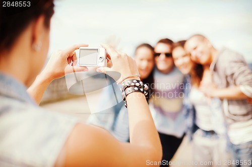 Image of close up of female hands holding digital camera