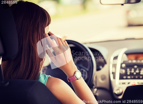 Image of woman using phone while driving the car