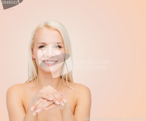 Image of face and hands of beautiful woman