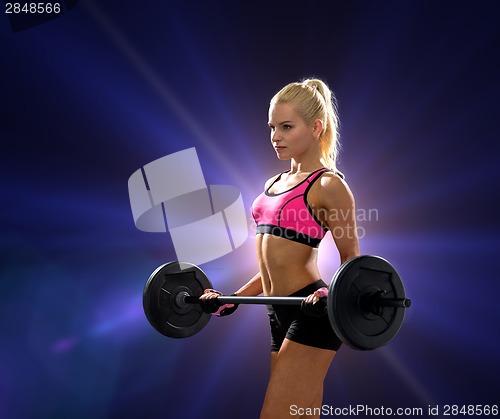 Image of sporty woman exercising with barbell