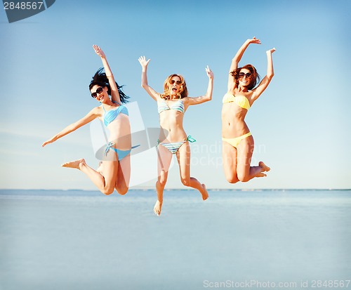 Image of girls jumping on the beach