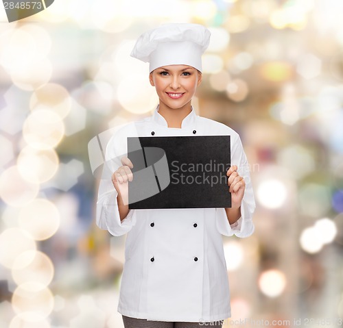 Image of smiling female chef with black blank paper