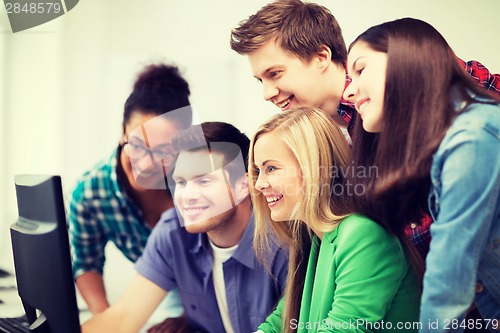 Image of students looking at computer monitor at school