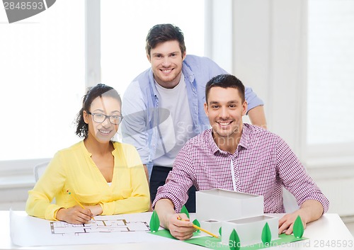 Image of smiling architects working in office