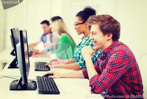 Image of student with computer studying at school