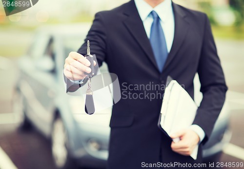 Image of man with car key outside