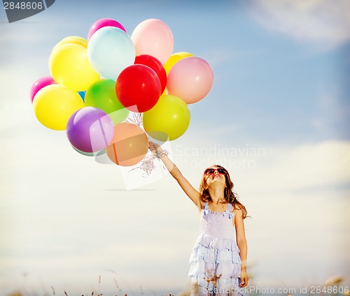 Image of happy girl with colorful balloons