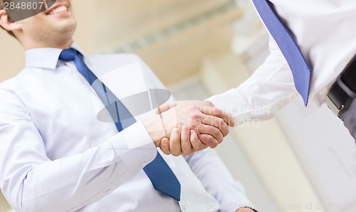 Image of two businessmen shaking hands in office