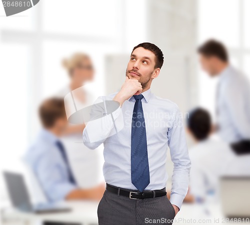 Image of handsome businessman looking up