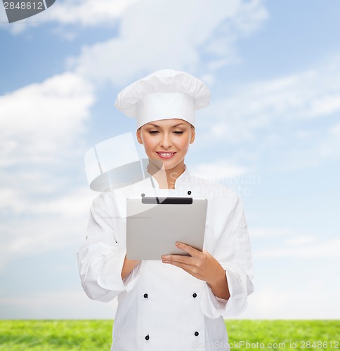 Image of smiling female chef with tablet pc computer