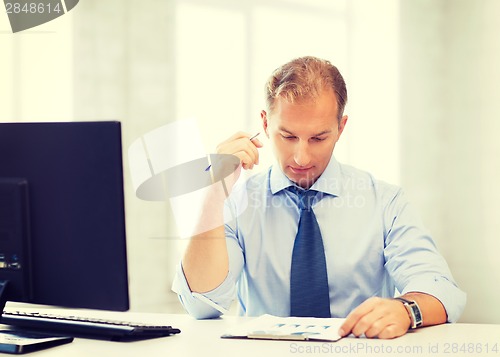 Image of businessman writing in notebook