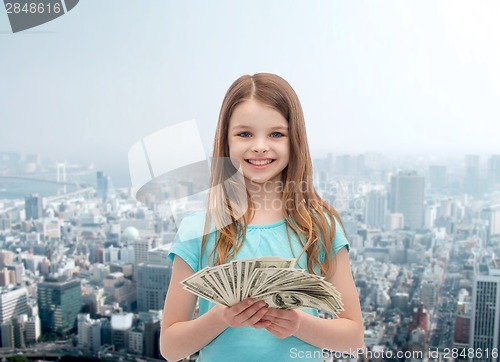 Image of smiling little girl with dollar cash money