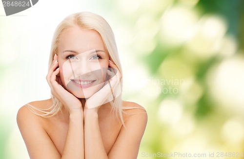 Image of beautiful woman touching her face skin