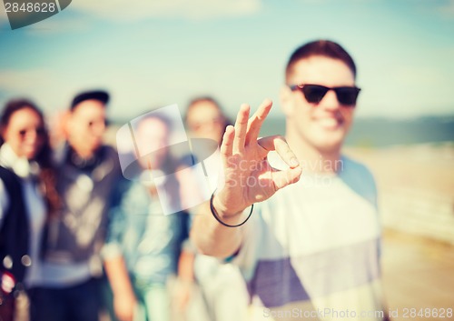 Image of close up of male hand showing ok sing with fingers