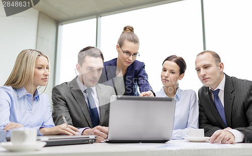 Image of business team with laptop having discussion