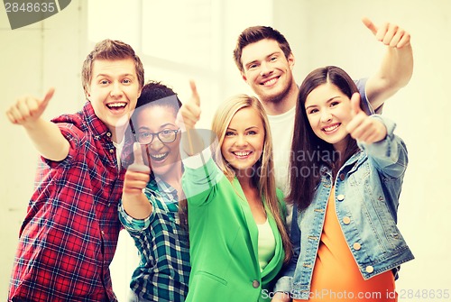 Image of students showing thumbs up at school