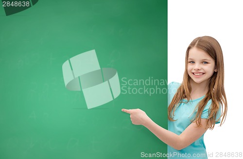 Image of happy little girl with blank blackboard