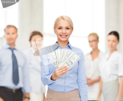 Image of young businesswoman with dollar cash money