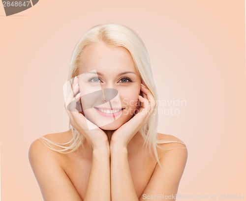 Image of beautiful woman touching her face skin