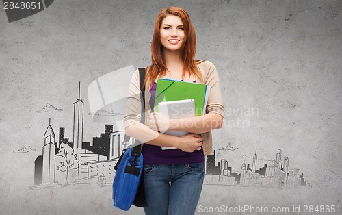 Image of smiling student with bag, folders and tablet pc