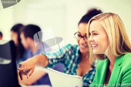 Image of students with computer studying at school